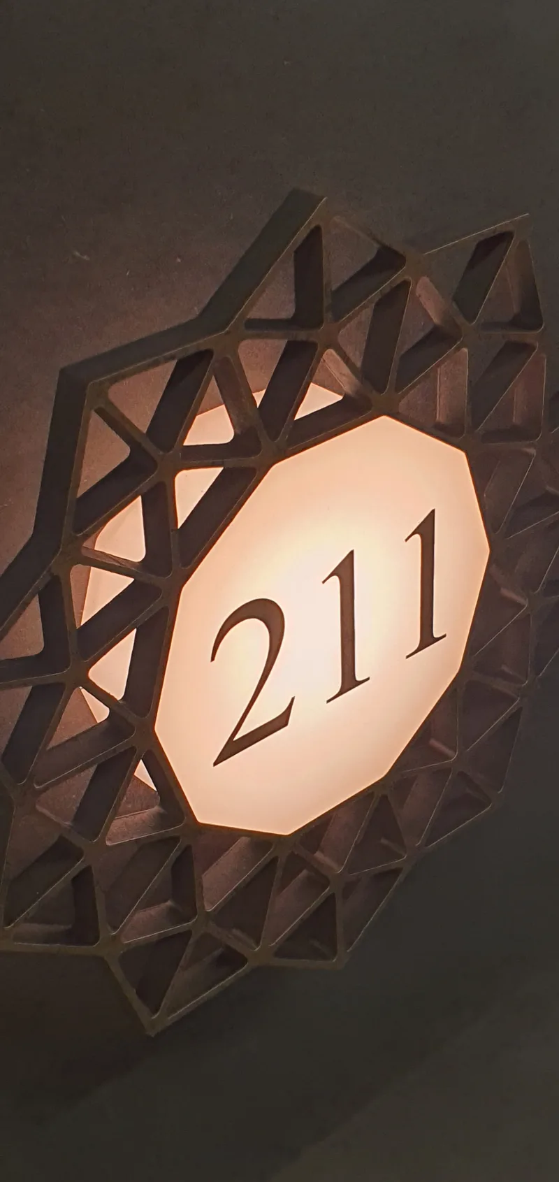 Backlit metal room number sign