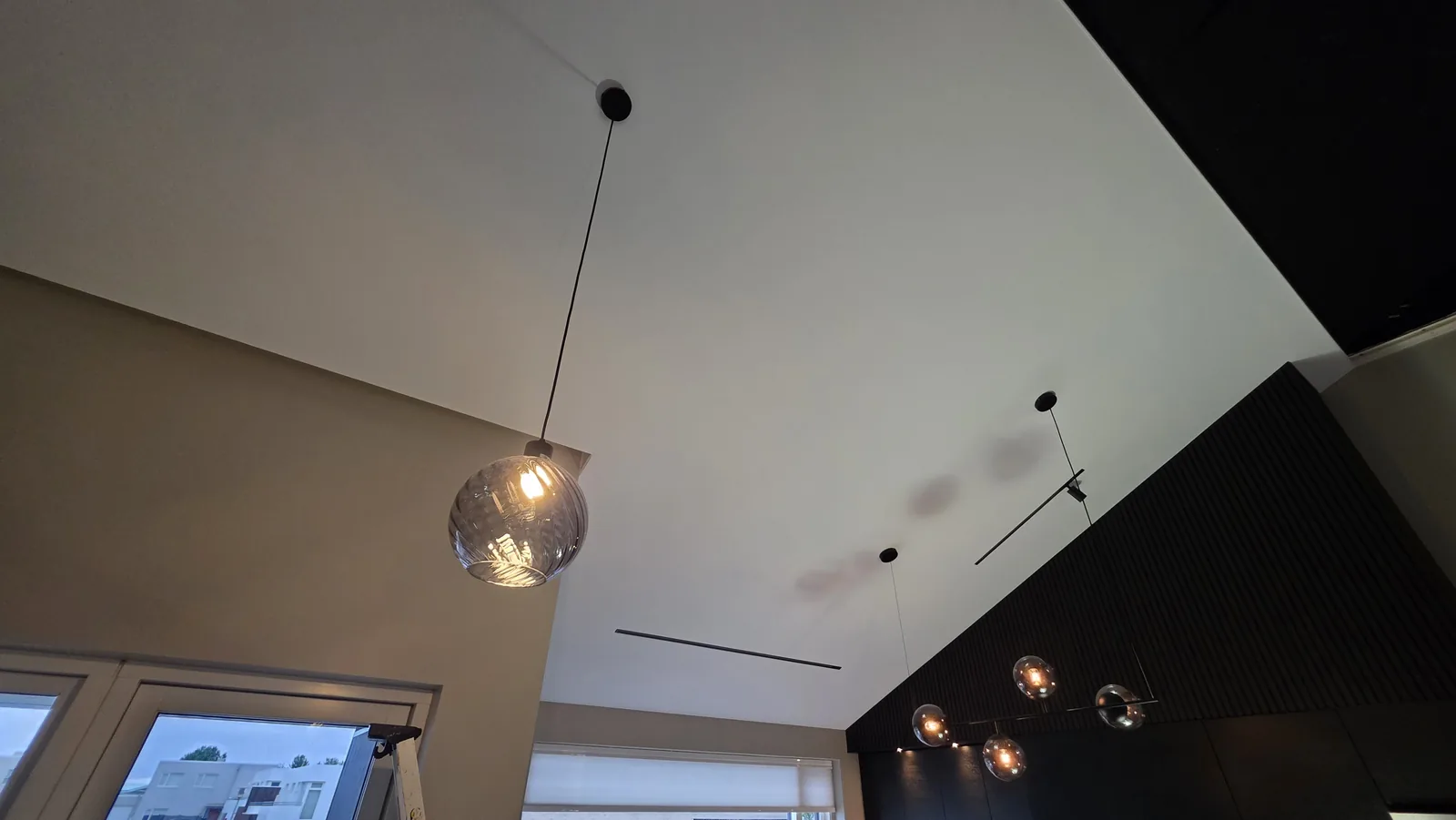 Clipso stretch ceiling over a living room and kitchen
