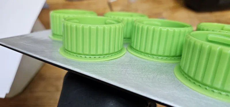 3D-printed prototype parts on a print bed